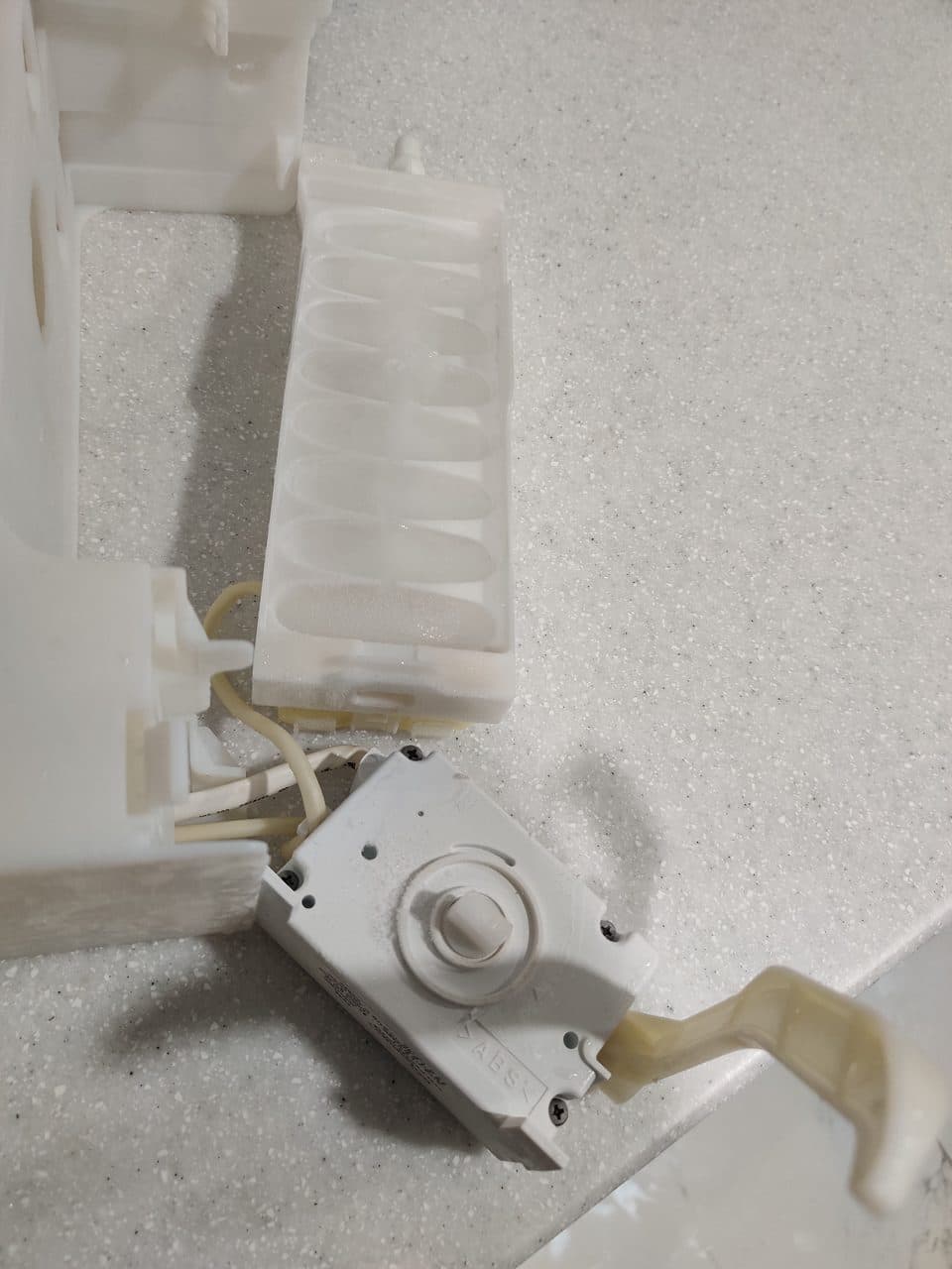 Refrigerator ice maker assembly removed: Samsung refrigerator, model RS25J500DSR (refrigerator repair in Miami Gardens, FL, August 2026)