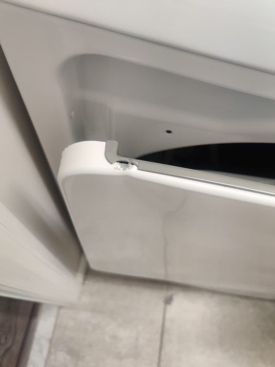 Damaged dryer door corner: GE dryer, model GTD45EASJ2WS (dryer repair in Palm Beach Gardens, FL, October 2026)