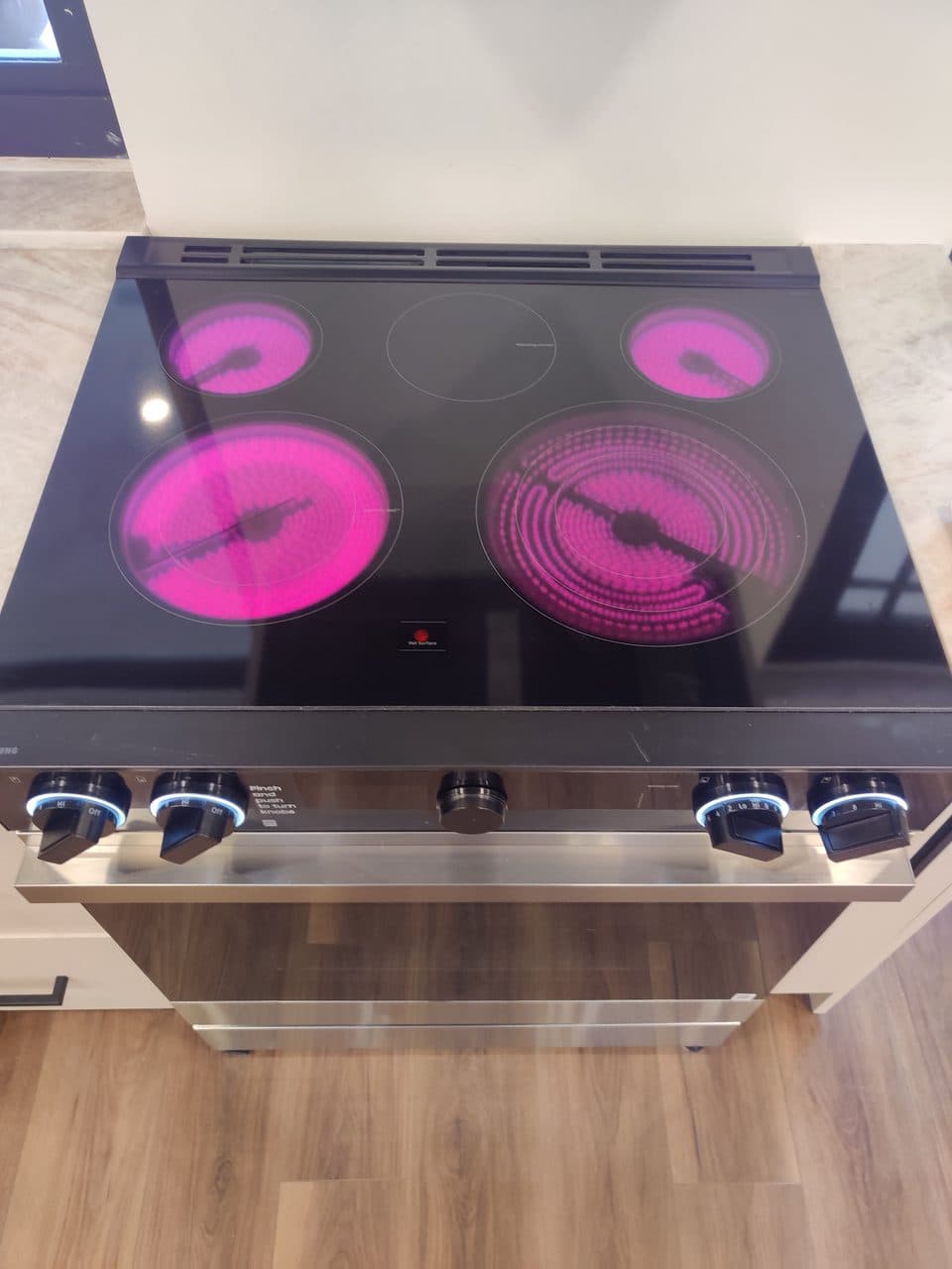 Glass-top electric range with all four burners heating