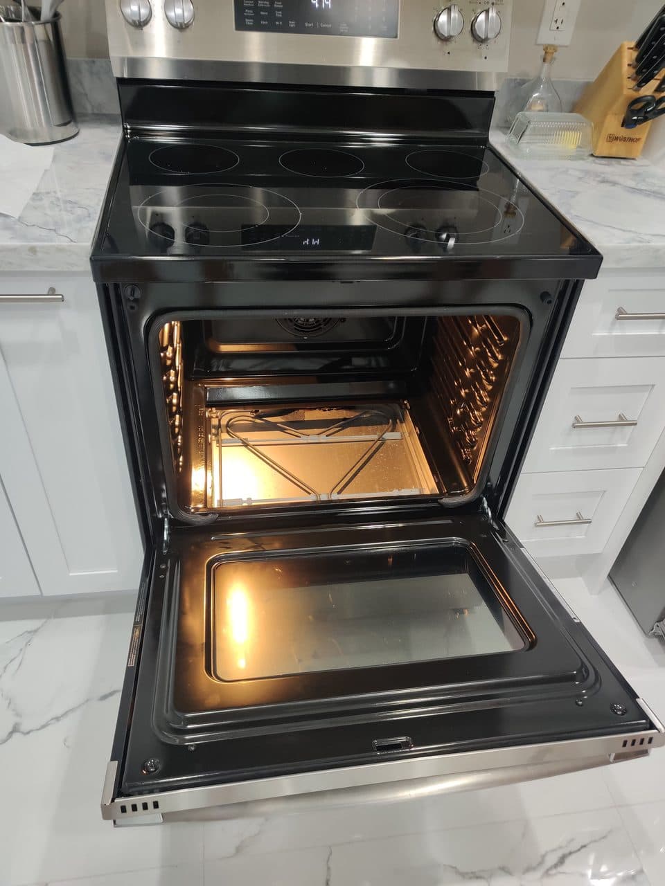 Freestanding electric range with the oven door open