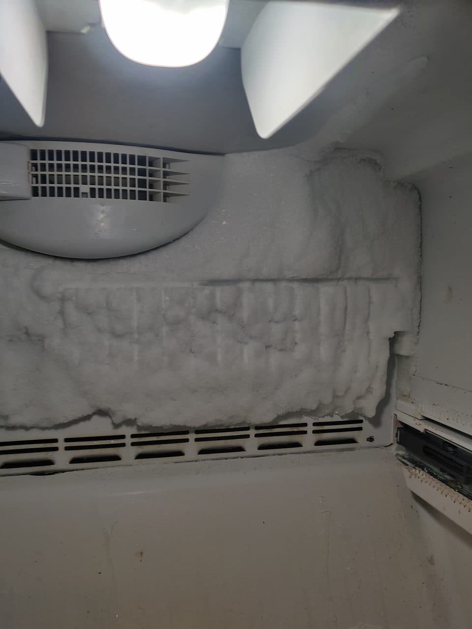 Frost built up on the back wall of a freezer