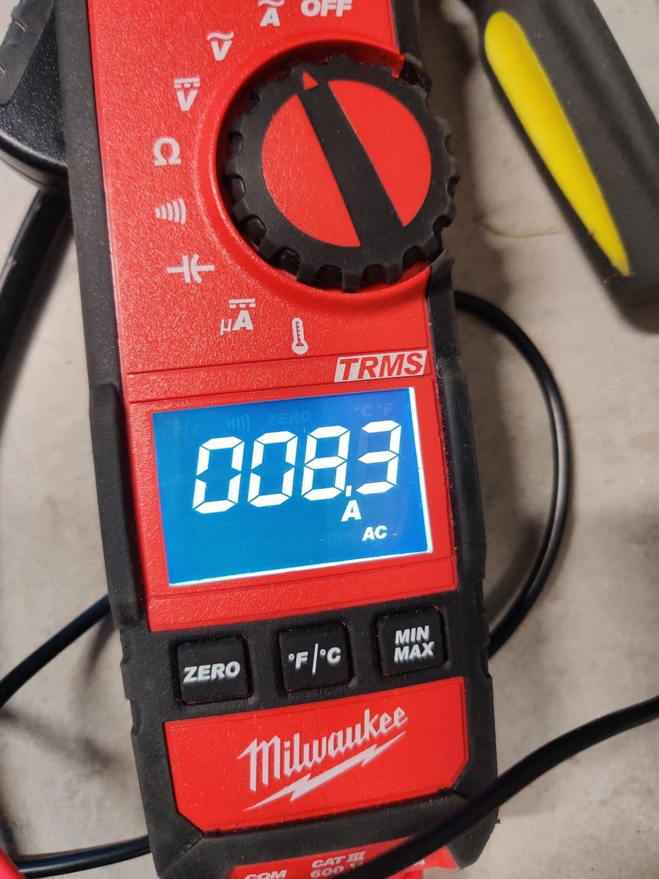 Clamp meter measuring an appliance's current draw